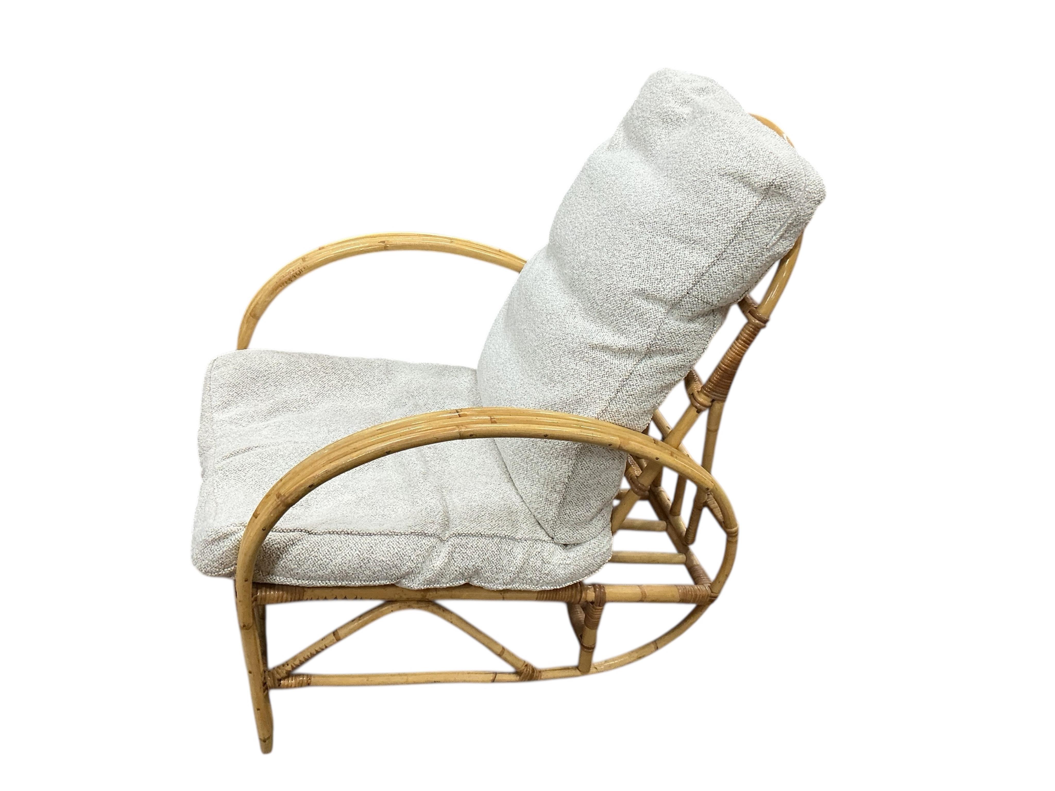 A mid century Angrave’s of Leicester “Invincible” bamboo suite comprising a pair of chairs, one brass mounted and reclining, a pair of matching footstools and a circular glass top occasional table, all with recently reup